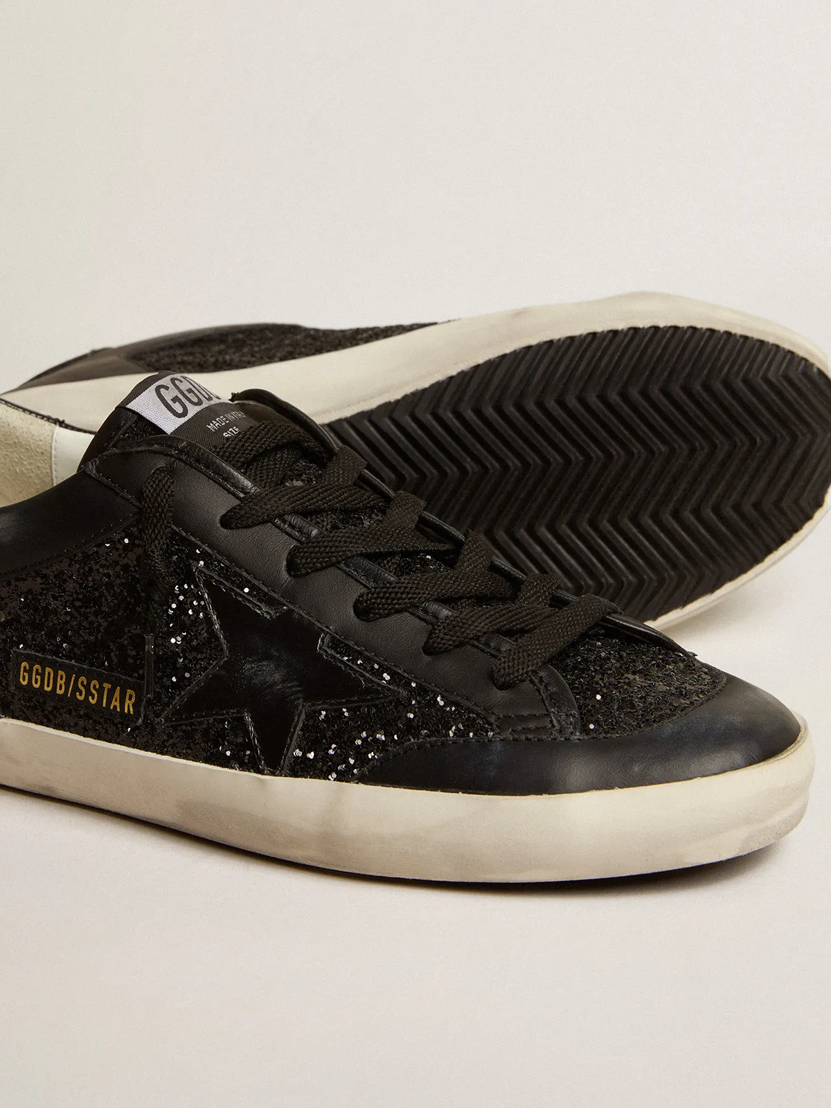 Super-Star in black nappa and glitter with glossy black leather star