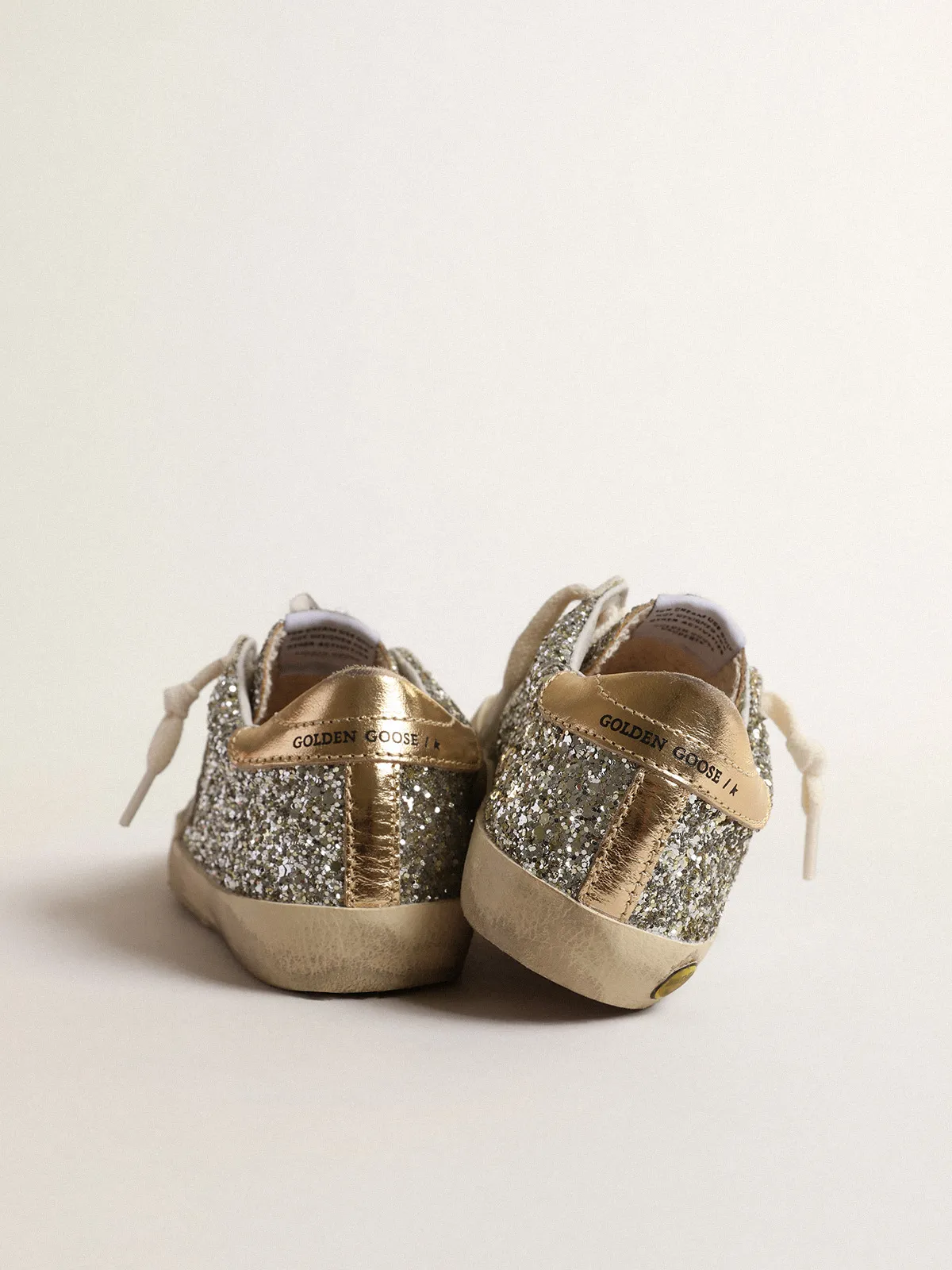 Super-Star Junior in glitter with a suede star and gold heel tab